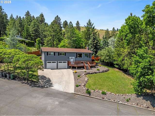 406 Balsa St, La Grande, OR 97850 - raised ranch featuring a wooden deck, an attached garage, driveway, a front yard, and stairs