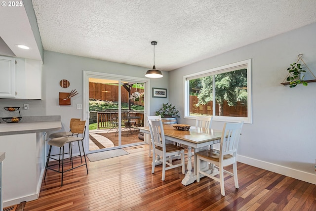 406 Balsa St, La Grande, OR 97850 - dining room with light wood-style flooring, baseboards, and a textured ceiling