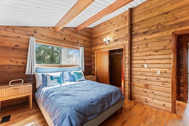 bedroom featuring wooden ceiling, visible vents, hardwood / wood-style floors, and lofted ceiling with beams