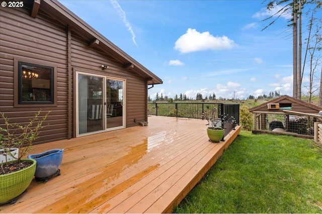 wooden terrace featuring a lawn