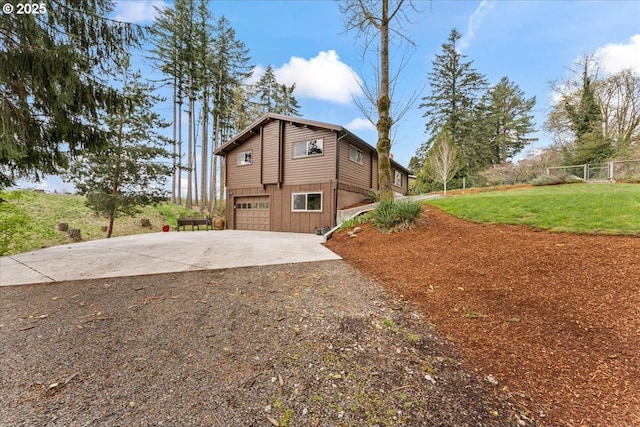 view of property exterior featuring driveway, a yard, and a garage