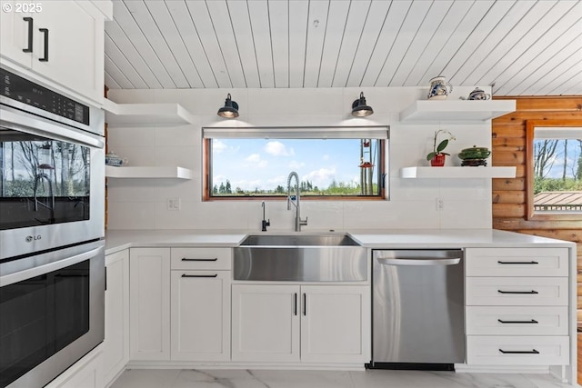kitchen featuring stainless steel appliances, marble finish floor, a sink, and open shelves