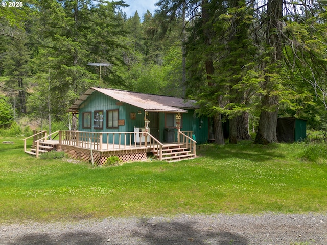 84932 Straw Springs Ln, Milton-Freewater, OR 97862 - rustic home with a view of trees, a deck, a front lawn, and metal roof
