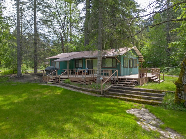 84932 Straw Springs Ln, Milton-Freewater, OR 97862 - view of front of property with a front yard, metal roof, a wooden deck, and a view of trees
