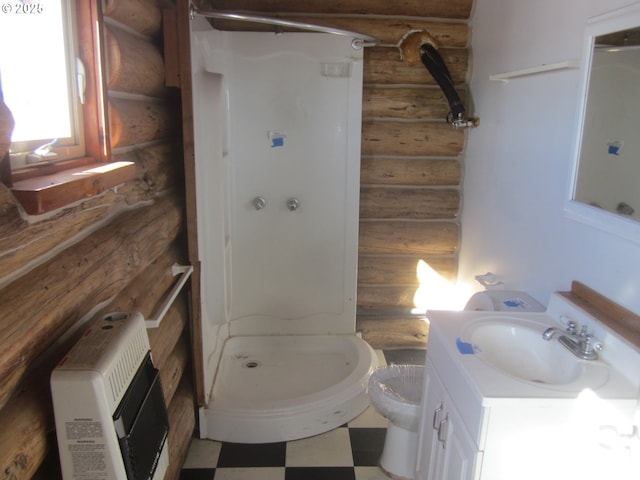 bathroom featuring toilet, tile patterned floors, heating unit, vanity, and a shower stall