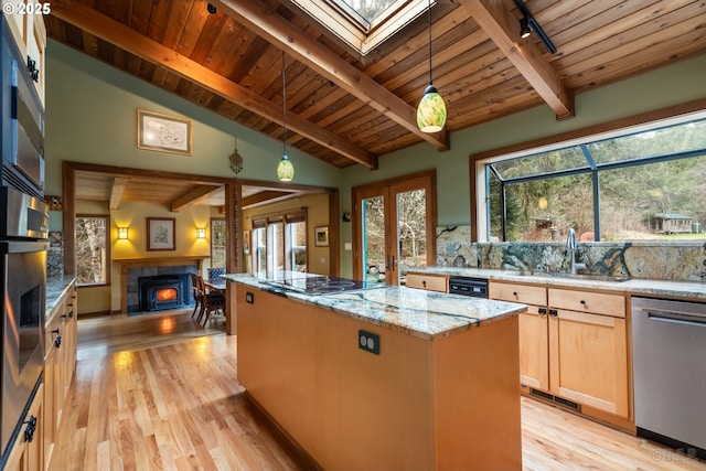 16637 Keasey Rd, Vernonia, OR 97064 - kitchen featuring stainless steel appliances, a tile fireplace, wood ceiling, a center island, and light wood finished floors