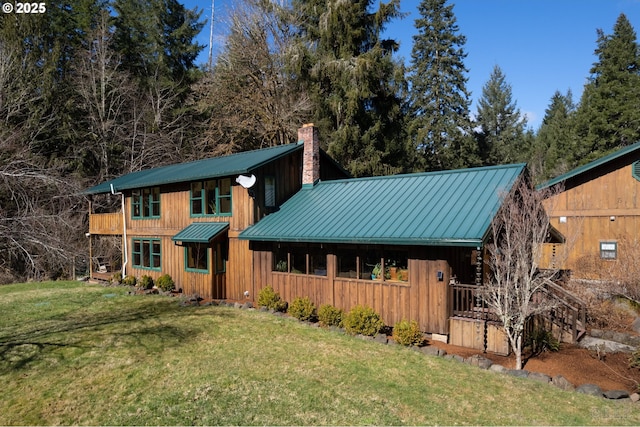 16637 Keasey Rd, Vernonia, OR 97064 - view of front facade featuring a chimney, a metal roof, a front lawn, and board and batten siding