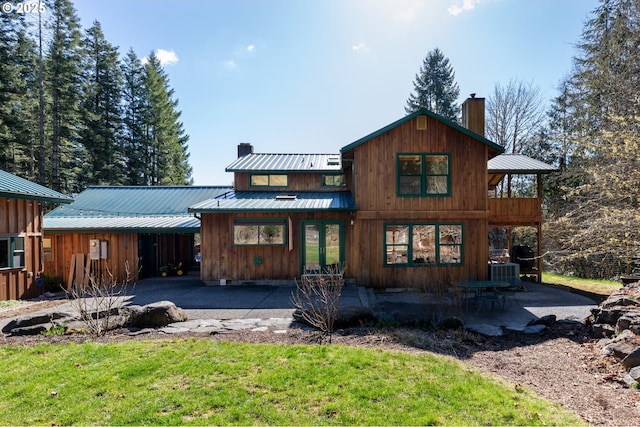 16637 Keasey Rd, Vernonia, OR 97064 - view of front of property with a chimney, french doors, a metal roof, and a patio