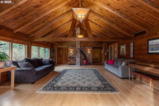 16637 Keasey Rd, Vernonia, OR 97064 - living room with a wood stove, wood walls, wood finished floors, high vaulted ceiling, and a wooden ceiling with exposed beams