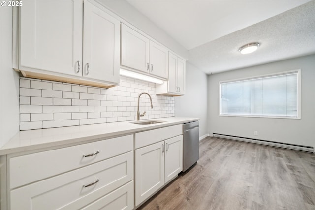 13155 SW Allen Blvd, Beaverton, OR 97005 - kitchen featuring dishwasher, a baseboard heating unit, a sink, decorative backsplash, and white cabinetry