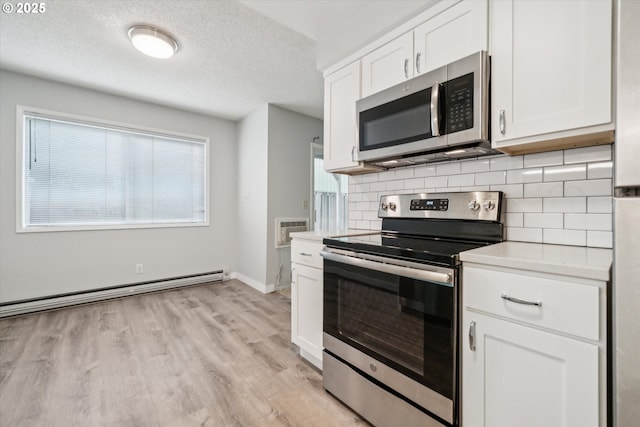 13155 SW Allen Blvd, Beaverton, OR 97005 - kitchen with stainless steel appliances, a baseboard radiator, backsplash, light countertops, and a textured ceiling