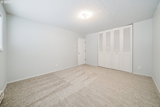 13155 SW Allen Blvd, Beaverton, OR 97005 - unfurnished bedroom with carpet floors, a closet, a textured ceiling, baseboard heating, and baseboards