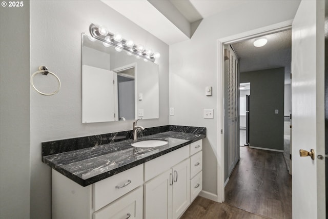 13155 SW Allen Blvd, Beaverton, OR 97005 - bathroom featuring wood finished floors, vanity, and baseboards