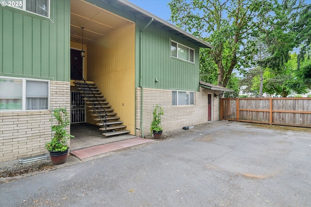 13155 SW Allen Blvd, Beaverton, OR 97005 - view of side of property with brick siding, stairs, and board and batten siding