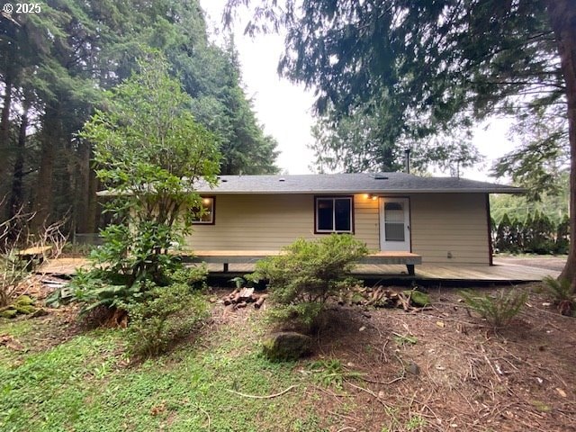 back of property featuring a wooden deck