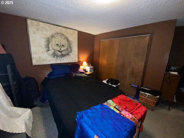 bedroom featuring a closet, a textured ceiling, and carpet