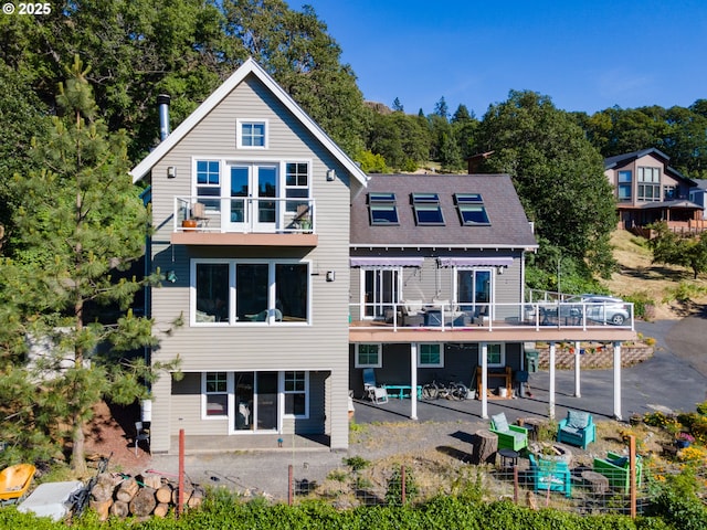 back of property featuring a patio and a balcony