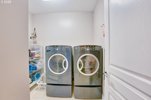 washroom with light tile patterned flooring and independent washer and dryer