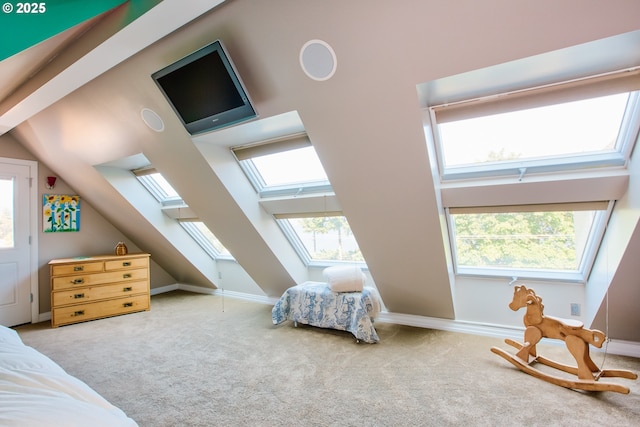 carpeted bedroom with lofted ceiling with skylight