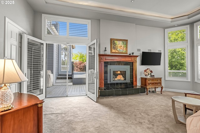 8623 Blackhawk Ct SE, Salem, OR 97317 - living room featuring carpet flooring, a tiled fireplace, crown molding, and baseboards