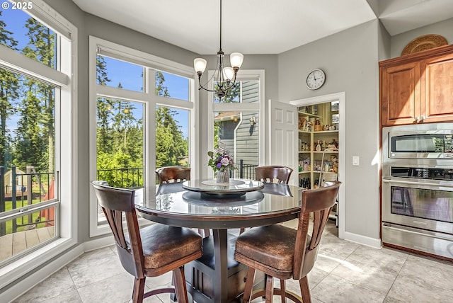 8623 Blackhawk Ct SE, Salem, OR 97317 - dining area with a chandelier, light tile patterned flooring, and baseboards