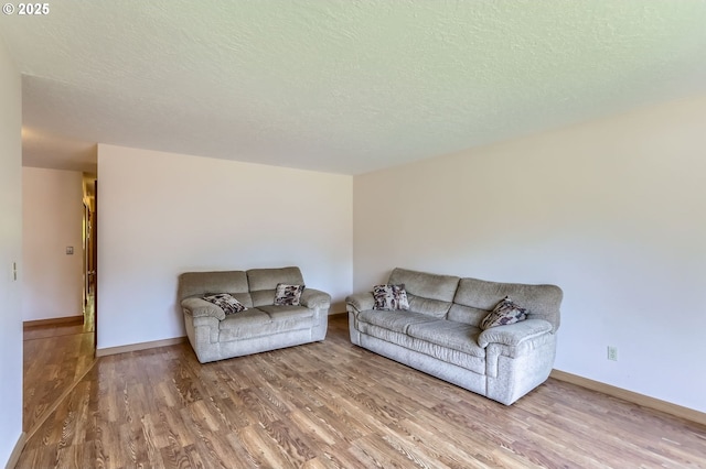 17708 SW Meadowbrook Way, Beaverton, OR 97078 - living room with wood finished floors, a textured ceiling, and baseboards
