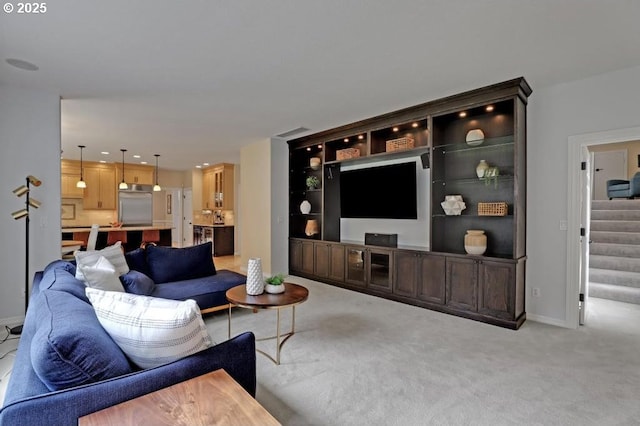 living room featuring carpet floors, baseboards, stairs, and visible vents