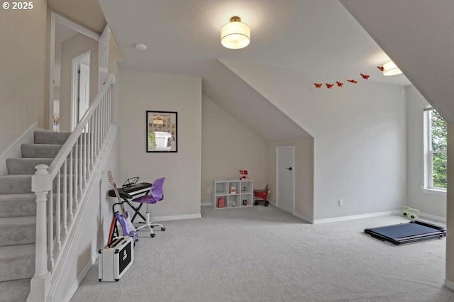 playroom featuring carpet floors, baseboards, and vaulted ceiling