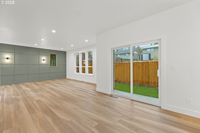 unfurnished living room featuring recessed lighting, visible vents, baseboards, and light wood finished floors