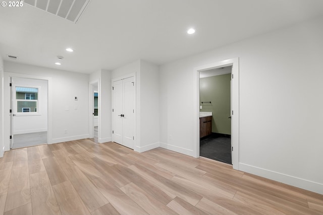 empty room with baseboards, recessed lighting, visible vents, and light wood-type flooring