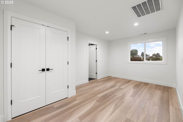 unfurnished bedroom featuring visible vents, recessed lighting, light wood-type flooring, and baseboards