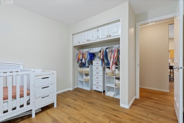 1218 Mt View Ln, Molalla, OR 97038 - bedroom with light wood-style flooring, a closet, and a textured ceiling