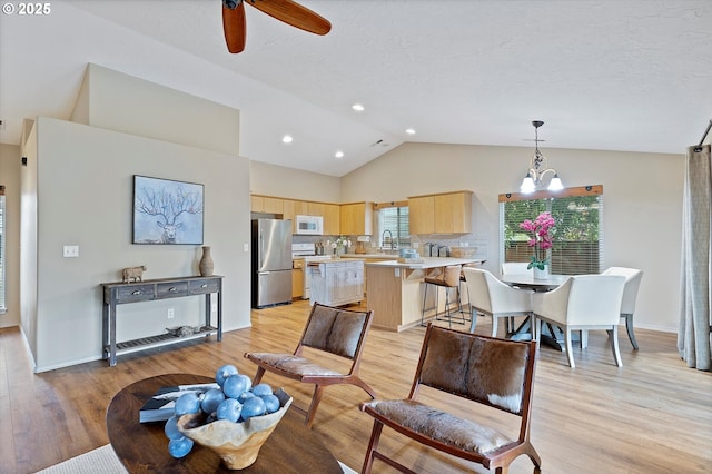 1218 Mt View Ln, Molalla, OR 97038 - living area featuring light wood finished floors, a chandelier, a ceiling fan, high vaulted ceiling, and a textured ceiling