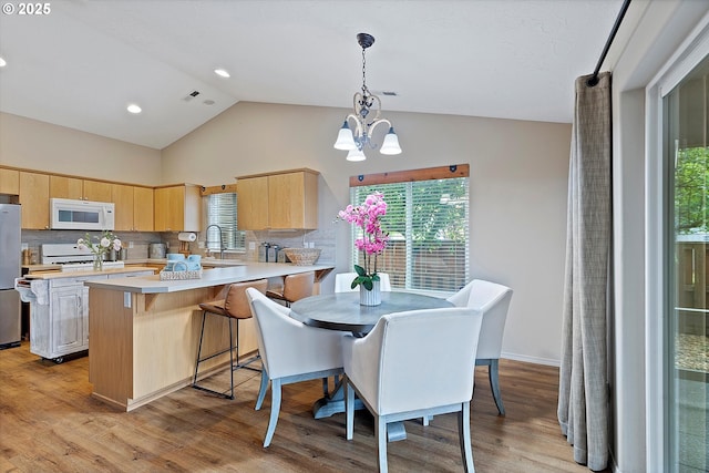 1218 Mt View Ln, Molalla, OR 97038 - kitchen with white microwave, light brown cabinets, light countertops, freestanding refrigerator, and a chandelier