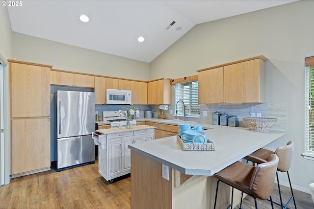 1218 Mt View Ln, Molalla, OR 97038 - kitchen with white appliances, light brown cabinets, light countertops, a peninsula, and decorative backsplash