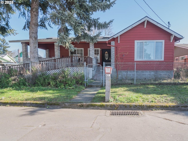 view of front of home with a fenced front yard and a gate