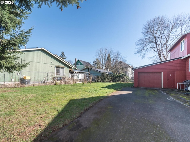 view of yard with a garage and driveway