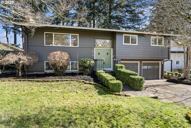 bi-level home with a front yard, driveway, and an attached garage