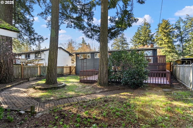 view of yard with a deck and a fenced backyard