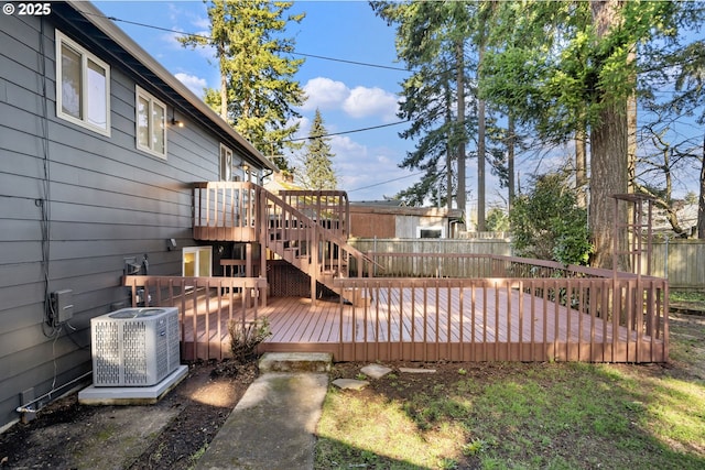 deck featuring stairs, central AC, and fence