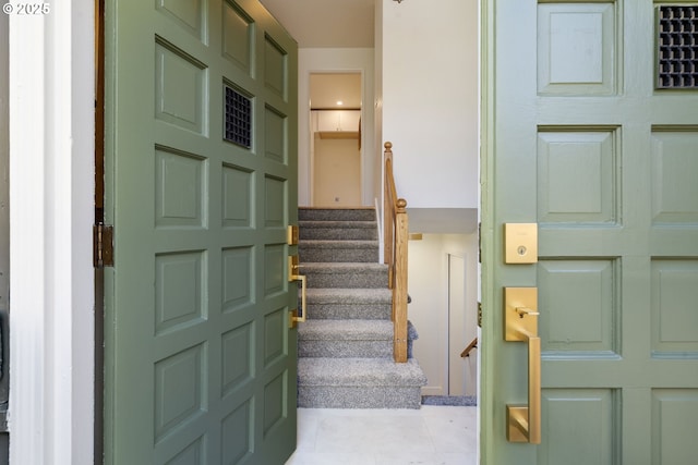 stairway featuring tile patterned flooring