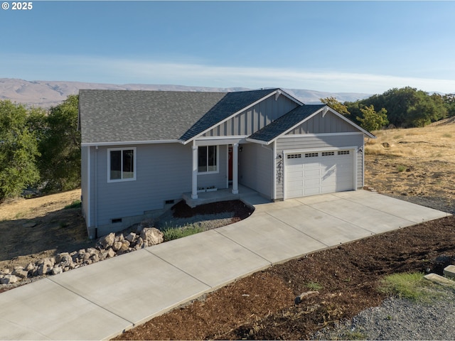 view of front facade with a garage and a mountain view