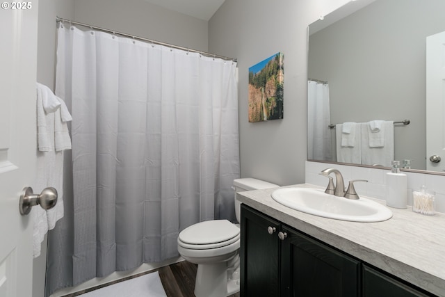 bathroom with vanity, hardwood / wood-style floors, and toilet