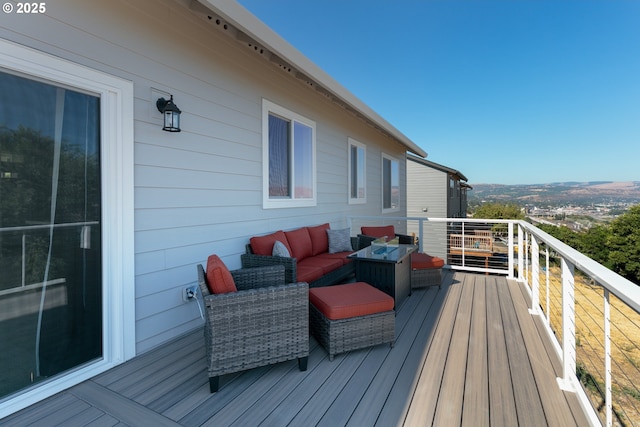 wooden terrace featuring an outdoor living space