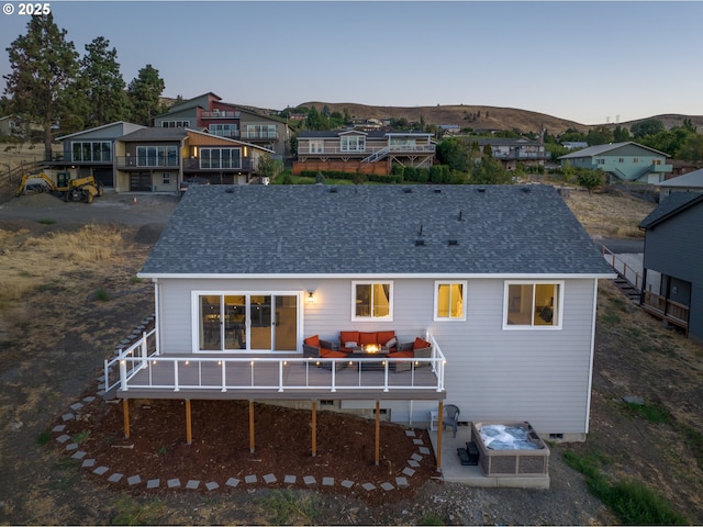 rear view of house with a deck with mountain view