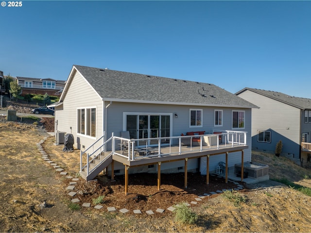 rear view of property featuring a wooden deck and central AC unit