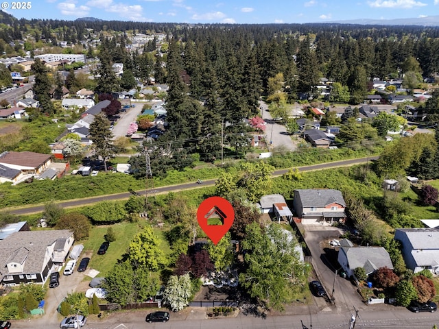 birds eye view of property with a wooded view and a residential view