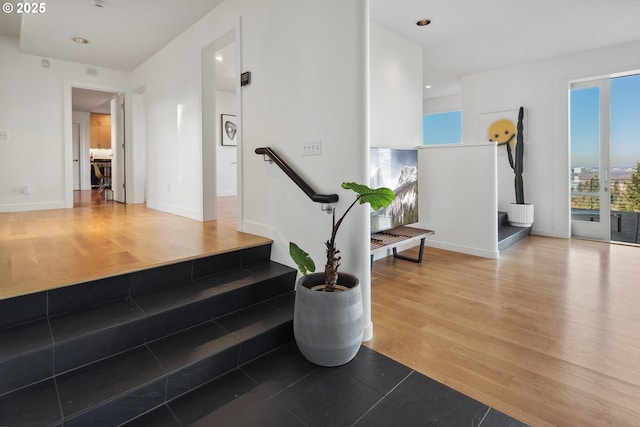 stairway with hardwood / wood-style flooring