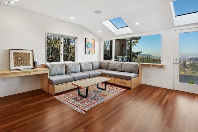 living room featuring dark wood-type flooring and vaulted ceiling with skylight