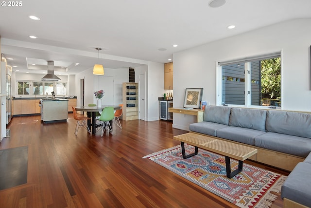 living room with wine cooler, sink, and dark hardwood / wood-style floors